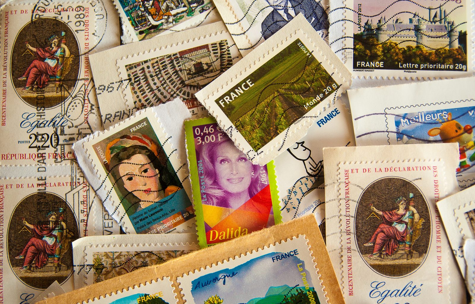 A spread of used French postage stamps with genuine postmarks
